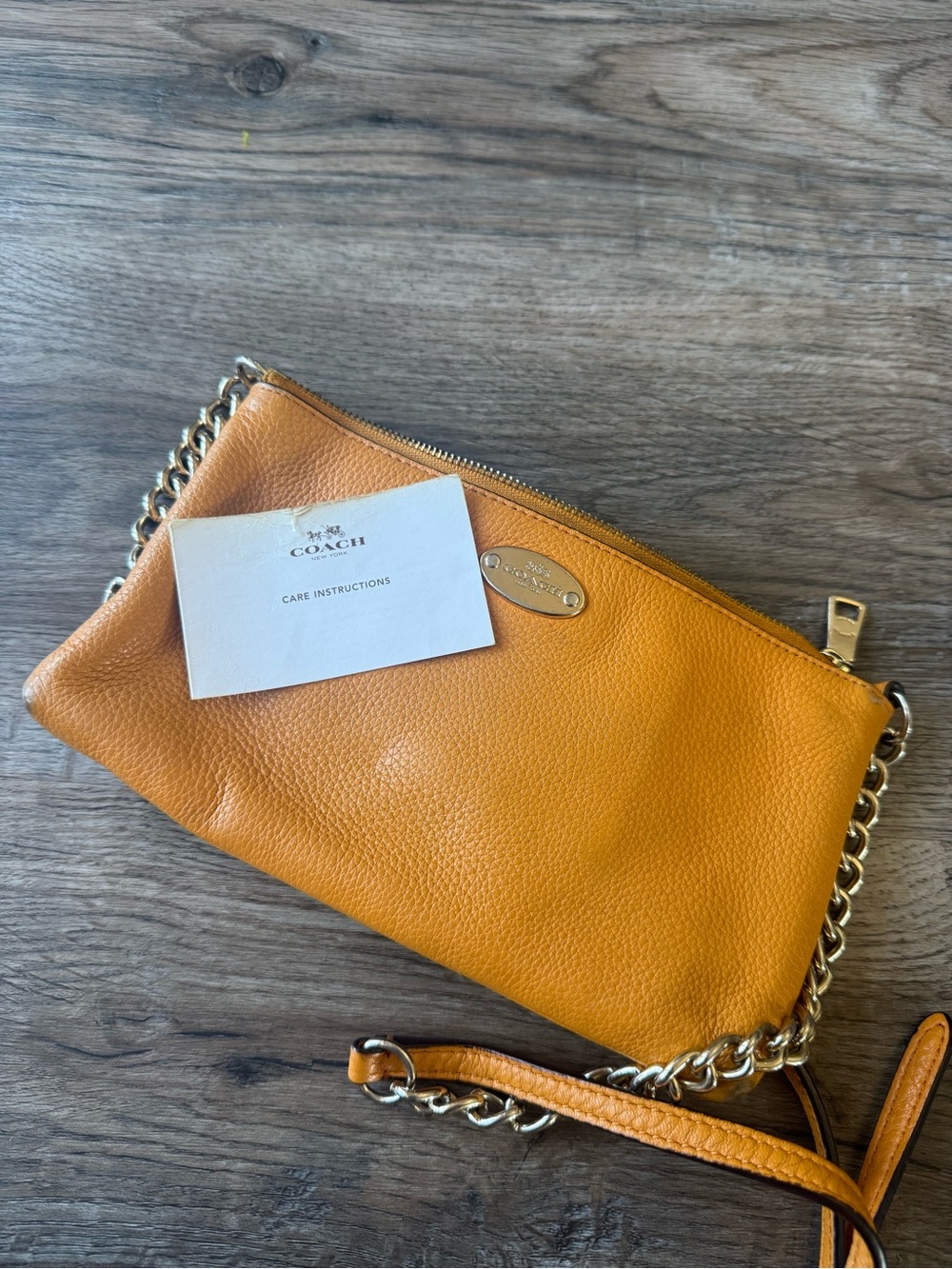 COACH Pebbled Leather Adjustable Over the Shoulder Zip Clutch in Mustard Yellow